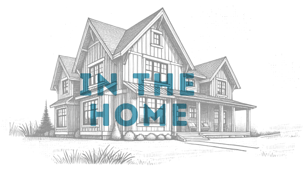 A black and white sketch of a two-story house with a porch, overlaid with the words "IN THE HOME" in bold blue letters, inspired by new homes in Montgomery County TX.