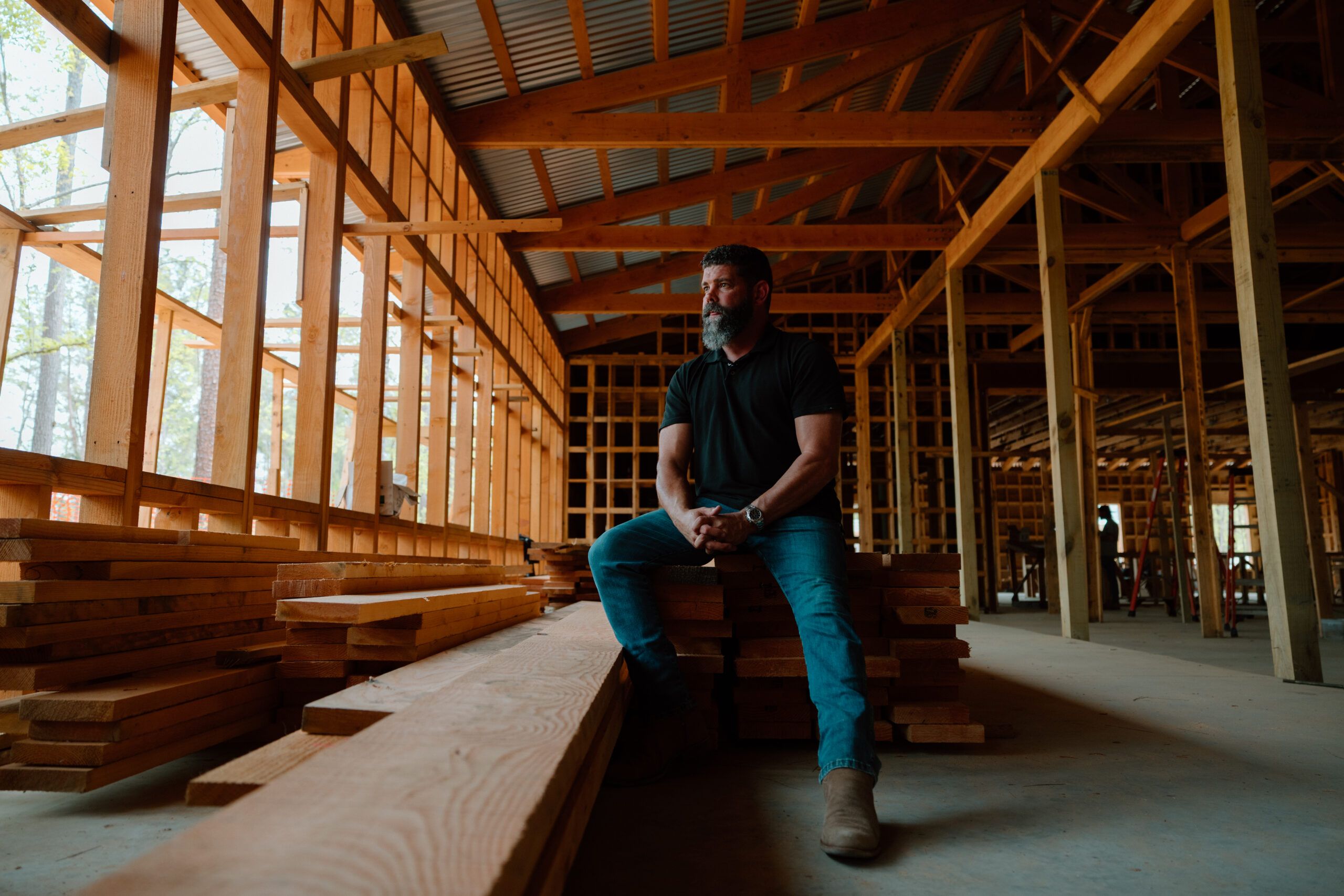 photo of man posing in front of construction site
